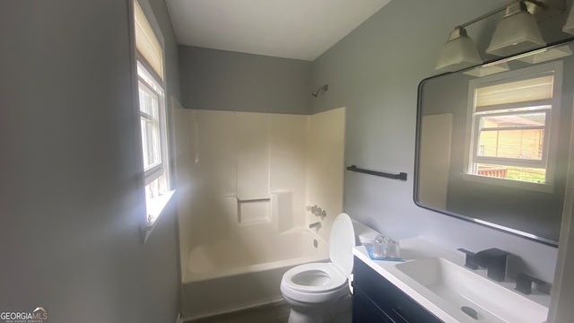 full bathroom featuring shower / bathing tub combination, vanity, and toilet