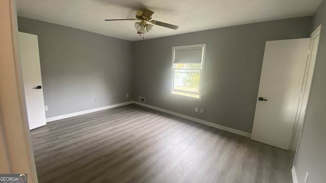 empty room with ceiling fan and hardwood / wood-style flooring