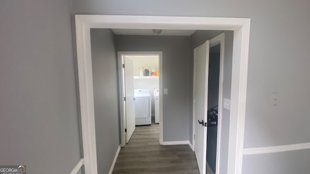 corridor with dark hardwood / wood-style floors and washing machine and clothes dryer