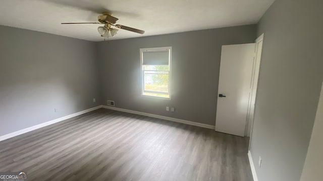 empty room featuring ceiling fan and wood-type flooring