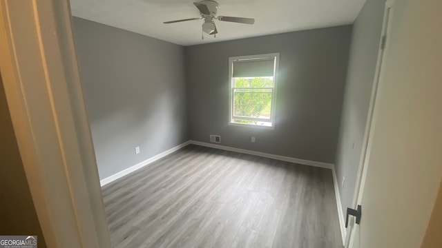 unfurnished room with ceiling fan and hardwood / wood-style floors