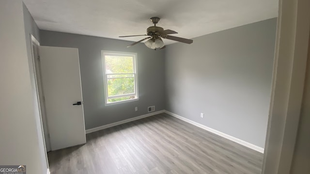 unfurnished room featuring ceiling fan and light hardwood / wood-style flooring