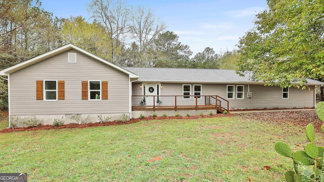 ranch-style house with a front yard and a deck