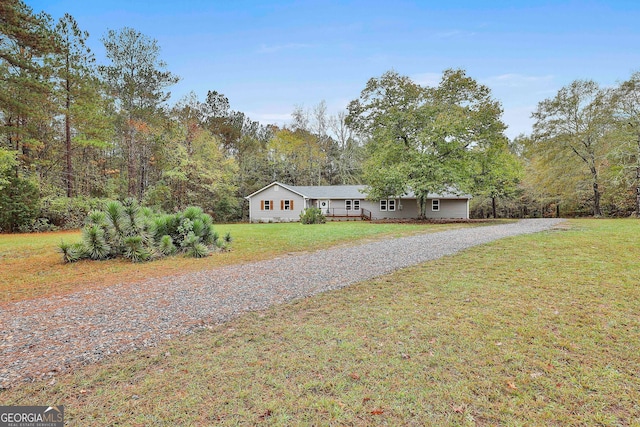 ranch-style home featuring a front lawn