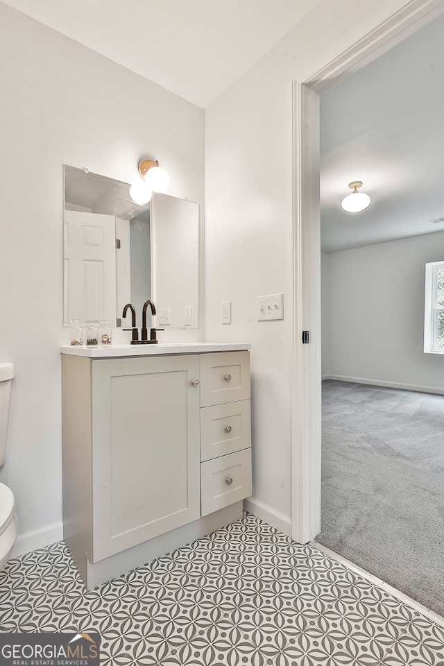 bathroom with vanity and toilet