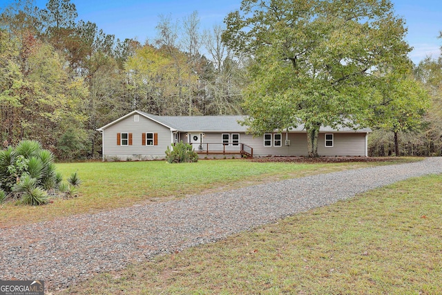 ranch-style home featuring a front yard