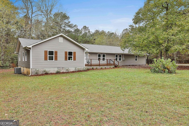 view of front of property with central AC, a wooden deck, and a front yard