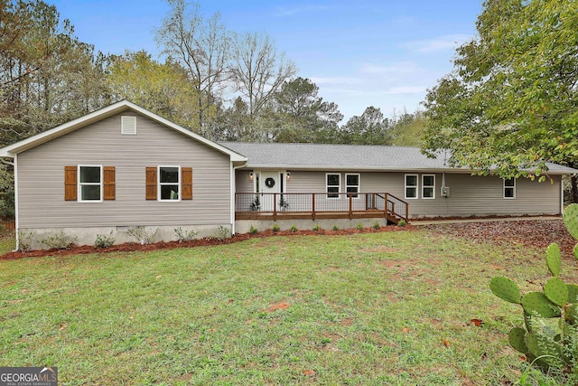 single story home featuring a deck and a front yard