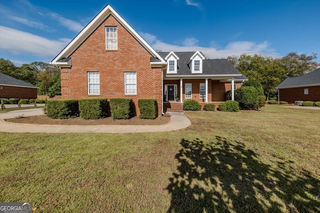 view of front property featuring a front lawn and covered porch