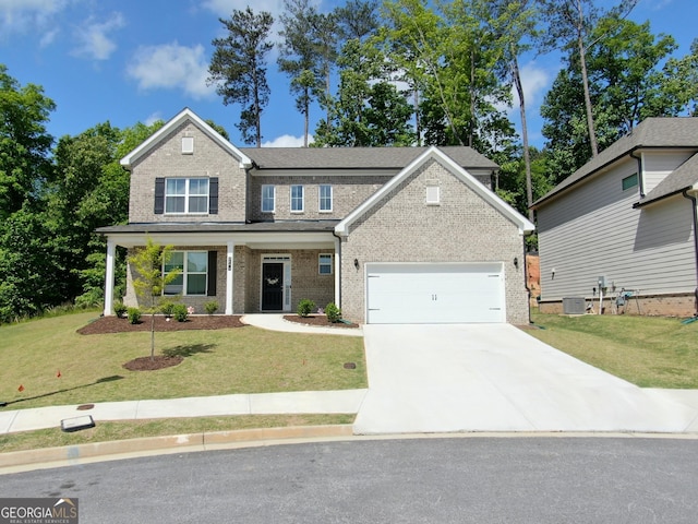 view of front of house featuring a garage, a front lawn, and central AC unit