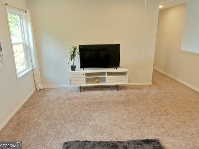 unfurnished living room featuring light carpet