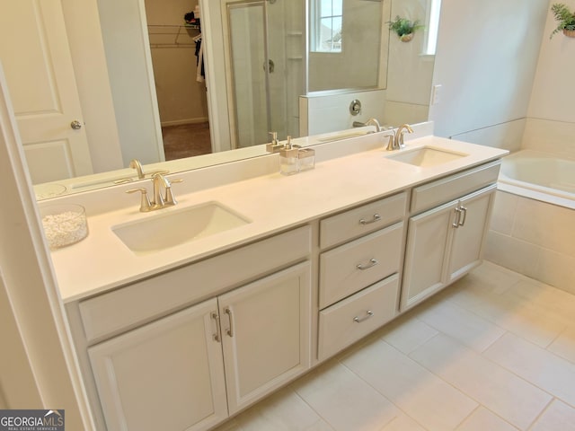 bathroom featuring tile patterned floors, separate shower and tub, and vanity