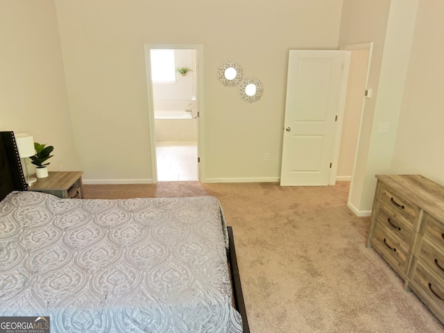 carpeted bedroom featuring ensuite bath