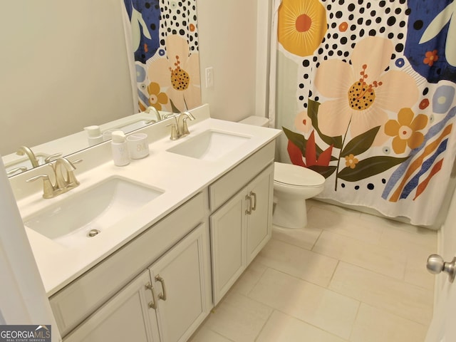 bathroom with tile patterned floors, vanity, and toilet