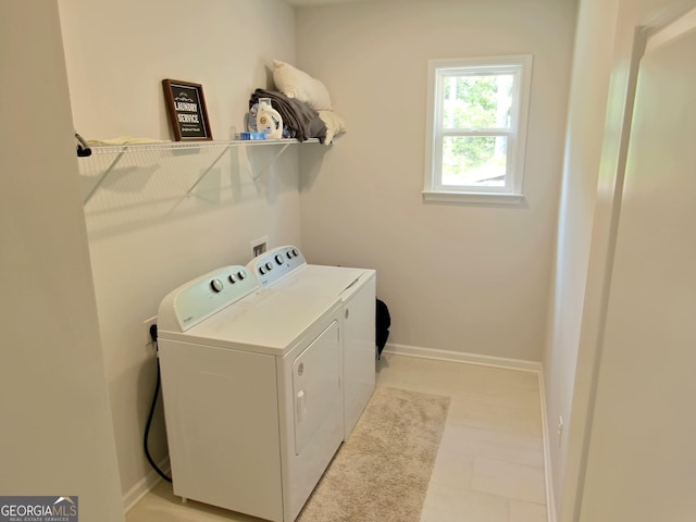 laundry area featuring washer and dryer and light tile patterned flooring