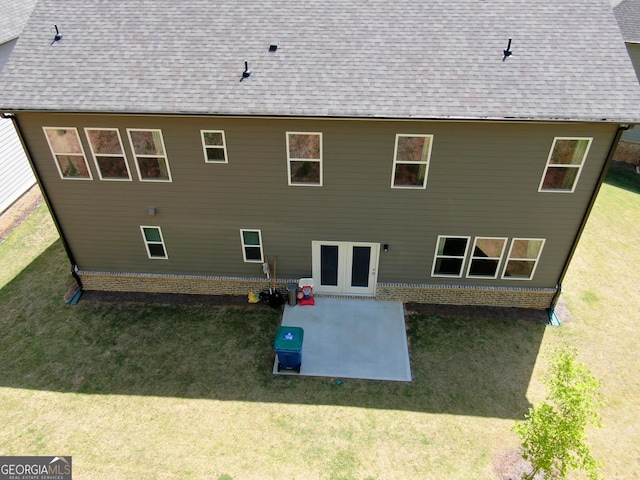 rear view of house featuring a yard