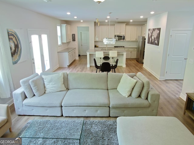 living room featuring sink and light hardwood / wood-style floors