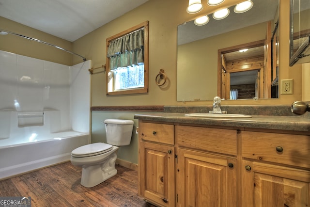 full bathroom with vanity, wood-type flooring, bathtub / shower combination, and toilet