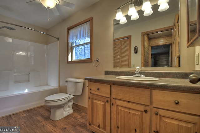 full bathroom featuring shower / bath combination, vanity, ceiling fan, wood-type flooring, and toilet