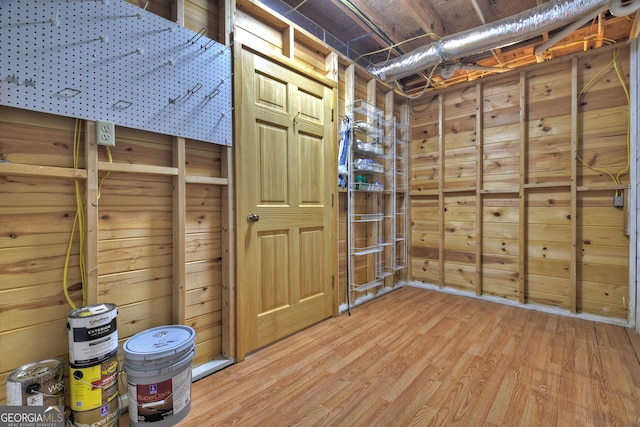 interior space featuring wood walls and hardwood / wood-style flooring