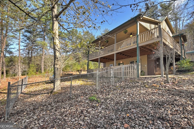 back of house featuring a wooden deck and ceiling fan