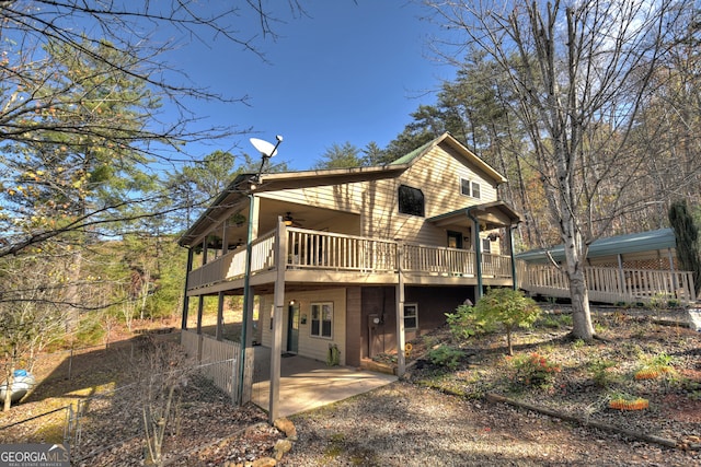 back of property featuring ceiling fan, a patio, and a wooden deck