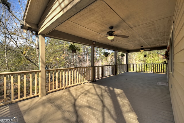 wooden deck featuring ceiling fan