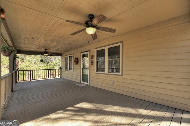 wooden terrace featuring ceiling fan