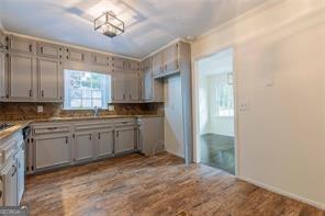 kitchen with wood-type flooring, sink, and decorative backsplash