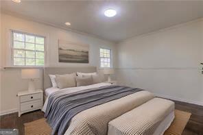 bedroom with dark hardwood / wood-style flooring