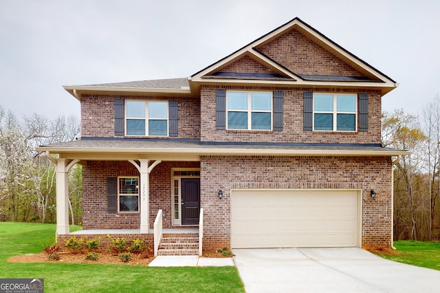 craftsman house with covered porch, a front yard, and a garage