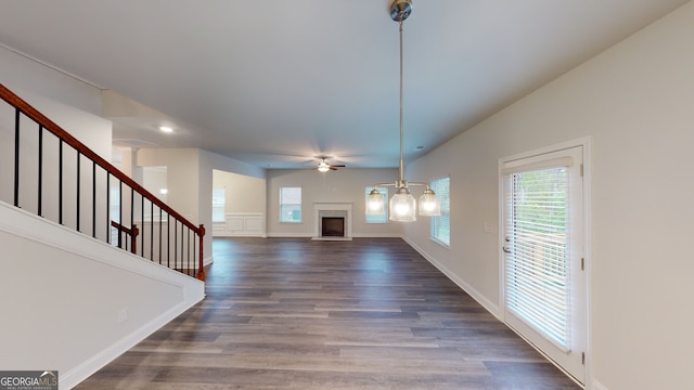 unfurnished living room featuring wood-type flooring and ceiling fan