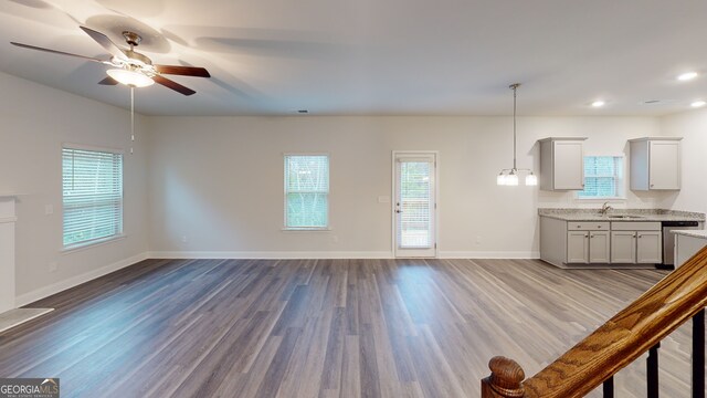 unfurnished living room featuring ceiling fan, sink, and light hardwood / wood-style flooring