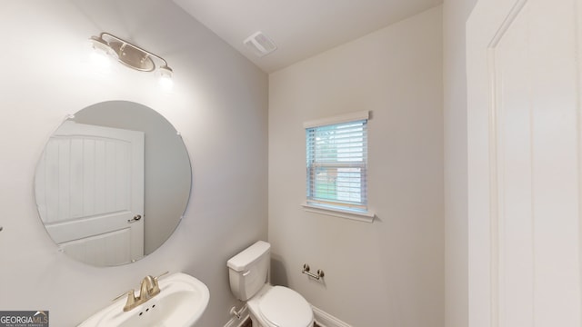 bathroom featuring toilet and sink