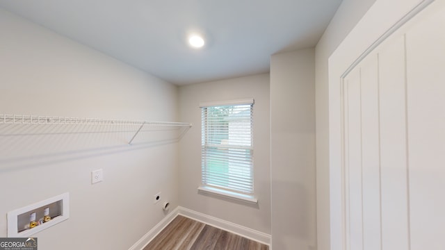 clothes washing area featuring hookup for an electric dryer, hardwood / wood-style floors, and hookup for a washing machine