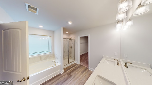 bathroom featuring independent shower and bath, vanity, and wood-type flooring