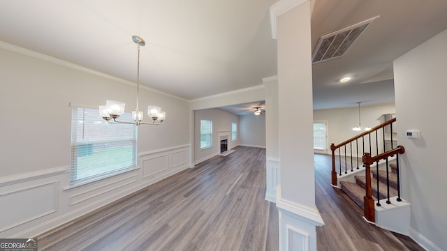 dining area with hardwood / wood-style flooring, plenty of natural light, and crown molding