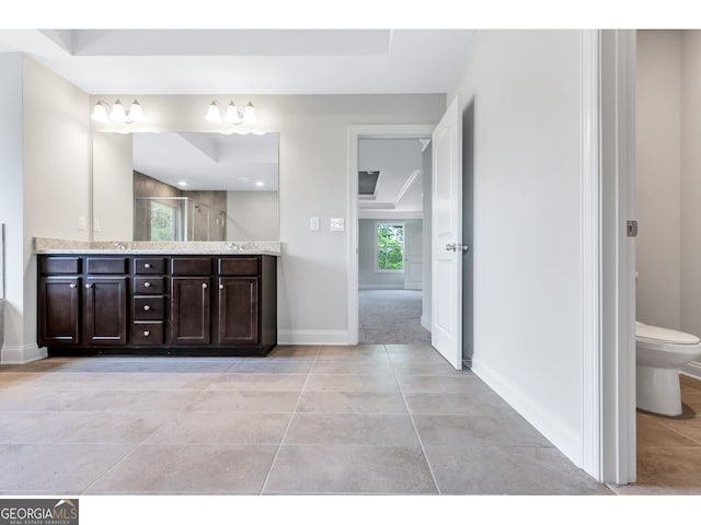 bathroom with tile patterned flooring, toilet, vanity, and walk in shower