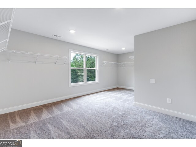 spare room featuring light colored carpet