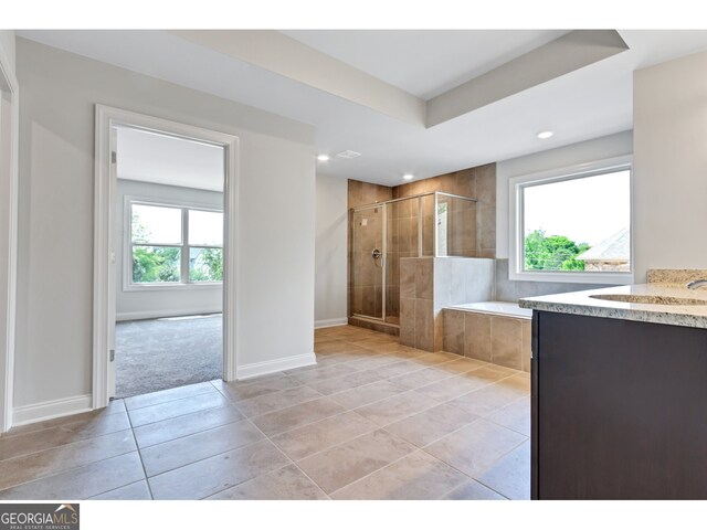 bathroom featuring separate shower and tub, tile patterned flooring, and vanity