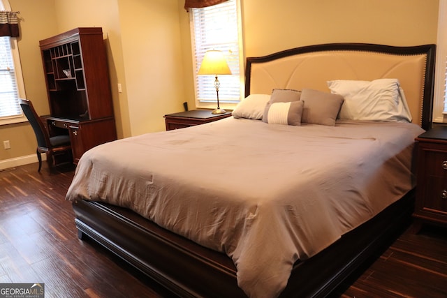 bedroom with dark wood-type flooring