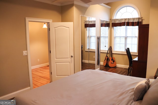 bedroom with crown molding and hardwood / wood-style flooring