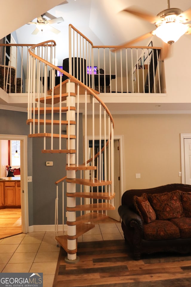 stairway featuring tile patterned floors, ceiling fan, and lofted ceiling