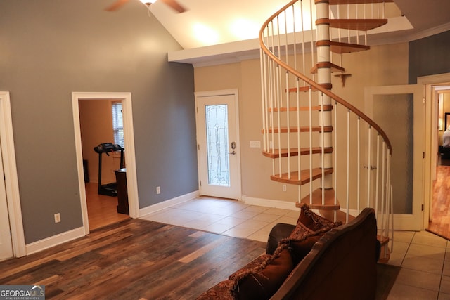 entrance foyer featuring hardwood / wood-style floors, high vaulted ceiling, and ceiling fan