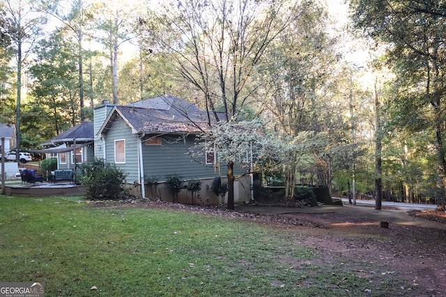 view of side of home featuring a yard