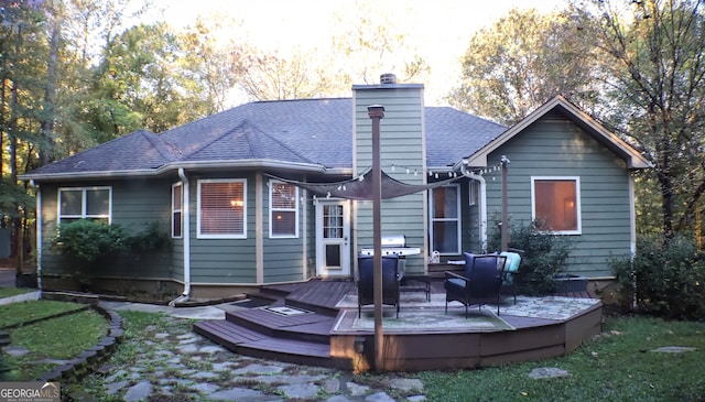 back of property featuring a wooden deck