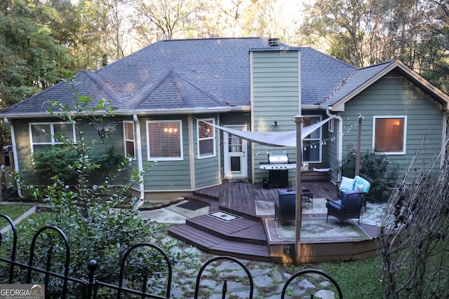 rear view of house with outdoor lounge area and a deck