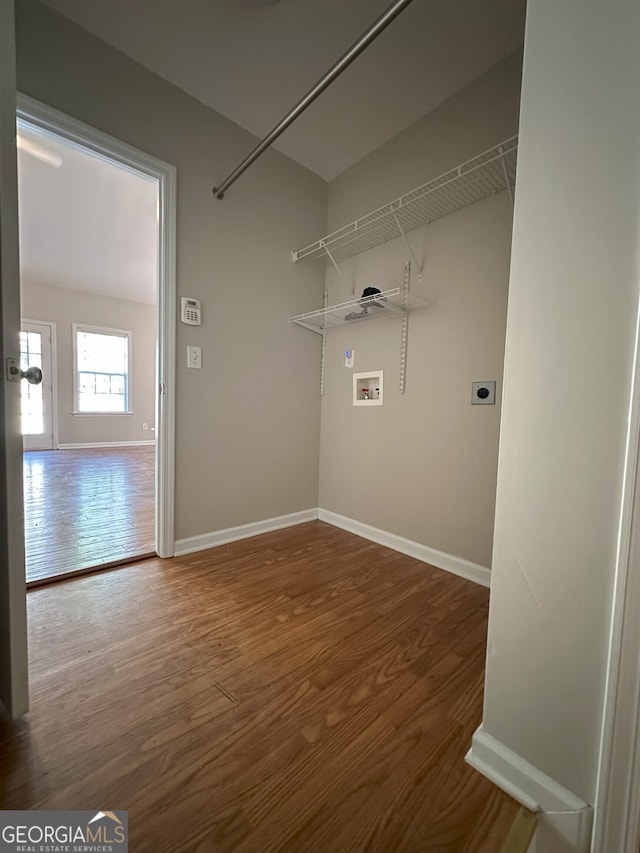 washroom with electric dryer hookup, hookup for a washing machine, and wood-type flooring