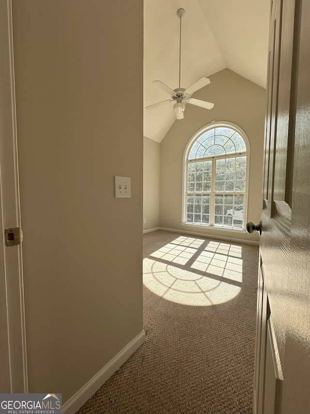 unfurnished living room with ceiling fan, carpet floors, and lofted ceiling