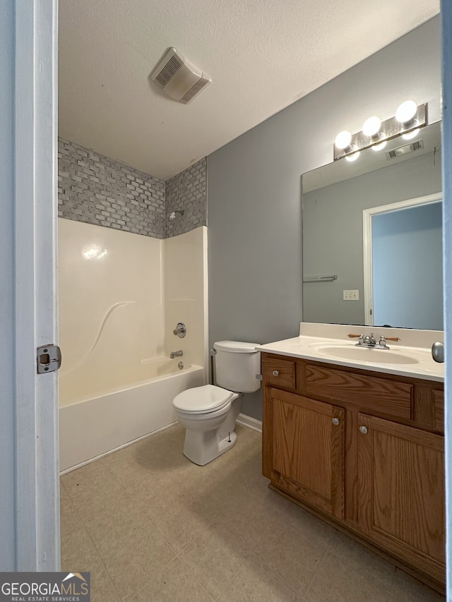 full bathroom featuring vanity, a textured ceiling, toilet, and  shower combination